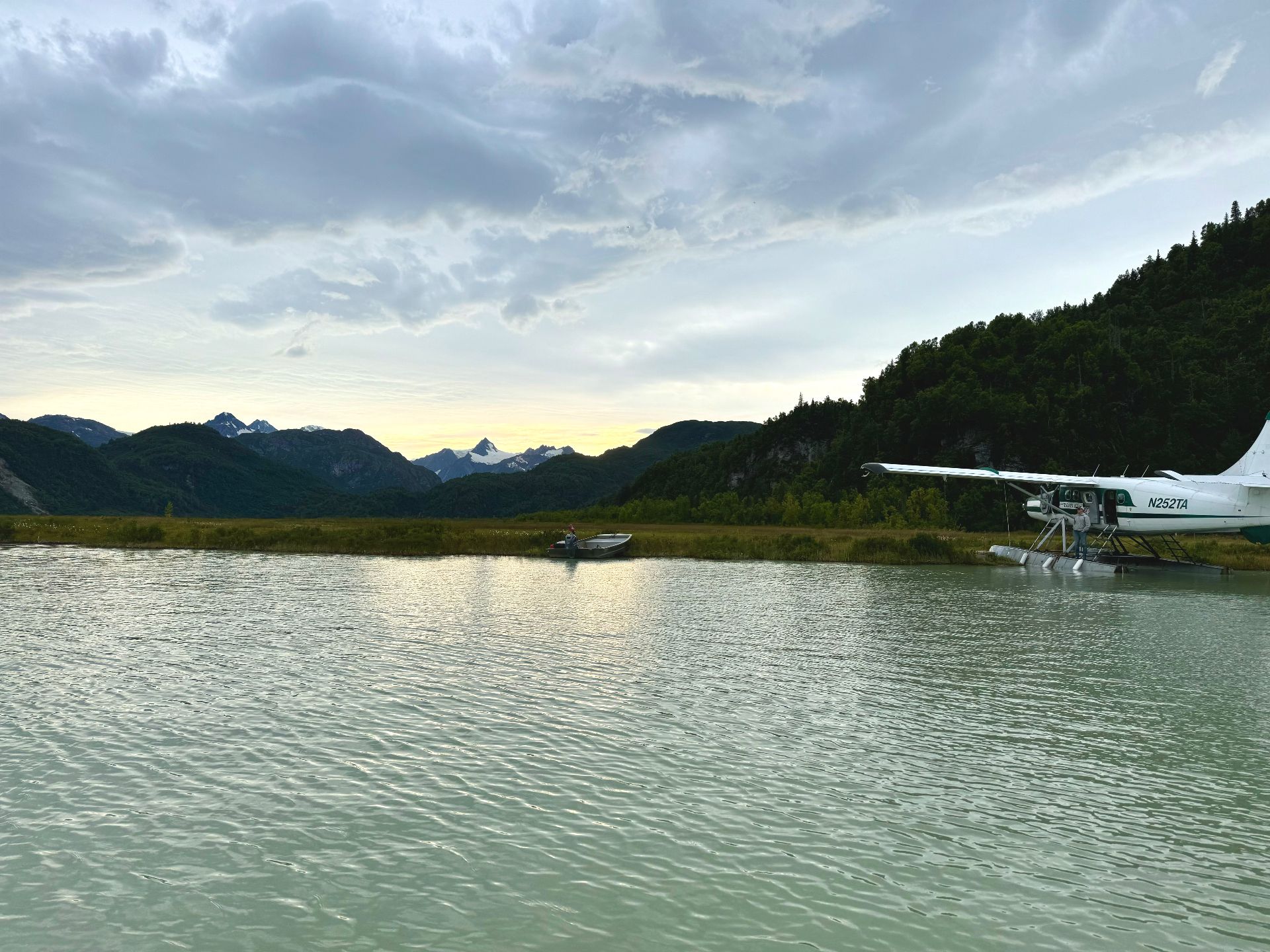 Float plane docked on a remote Alaskan lake with mountains in the background