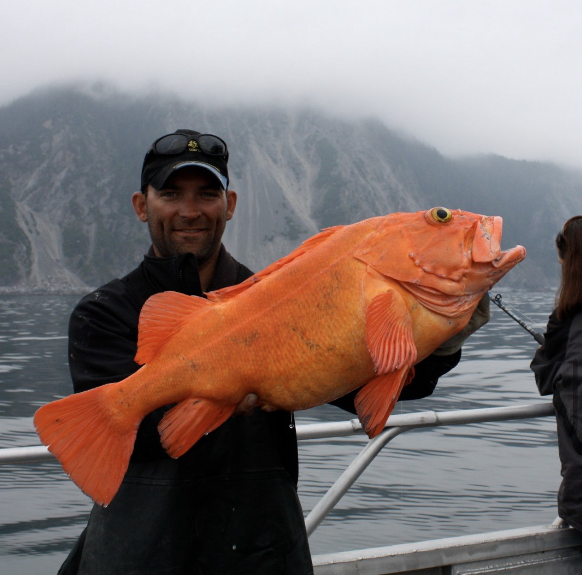 Angler holding a large yelloweye rockfish in Resurrection Bay