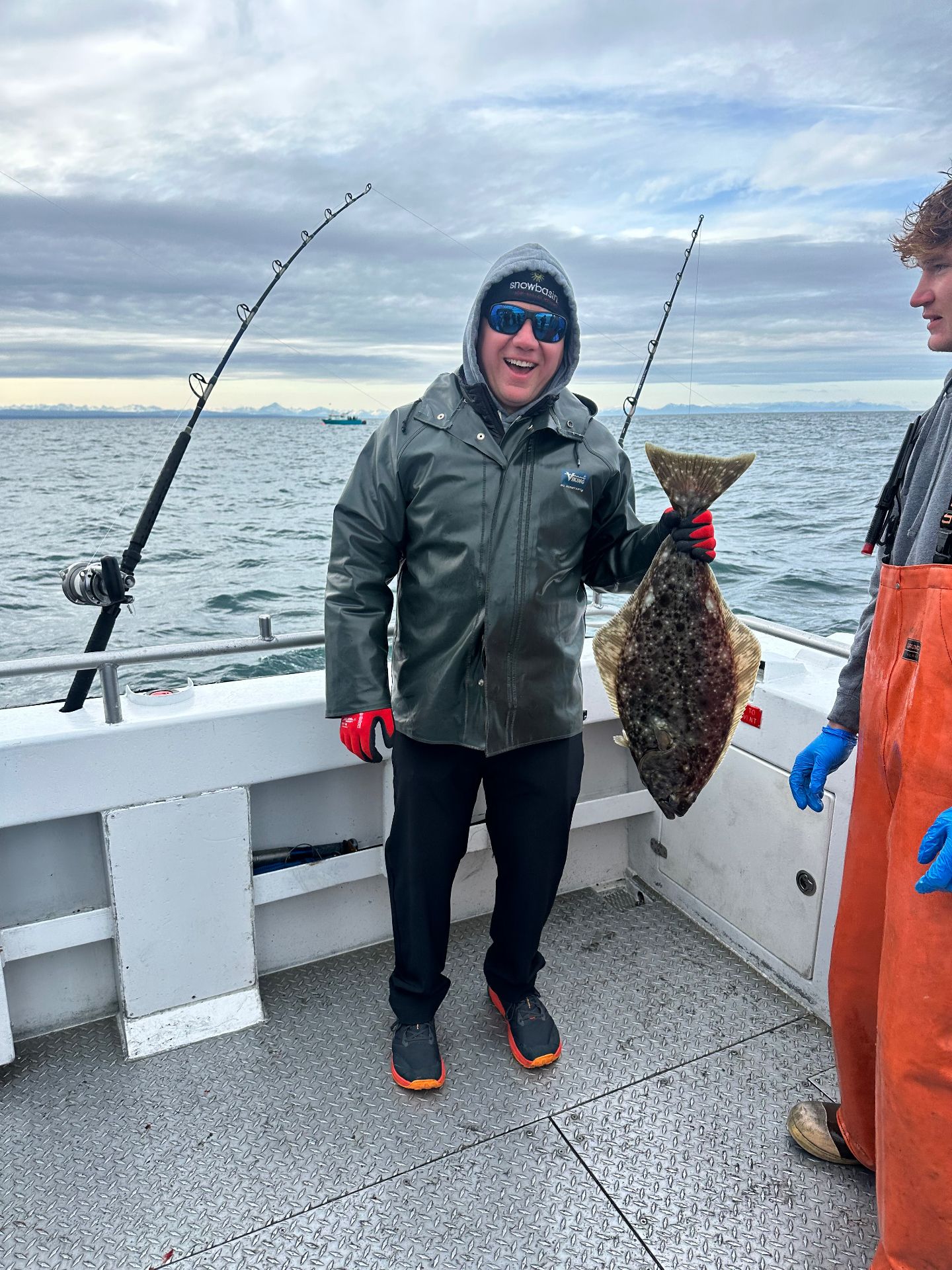 Angler holding a halibut on a Cook Inlet charter