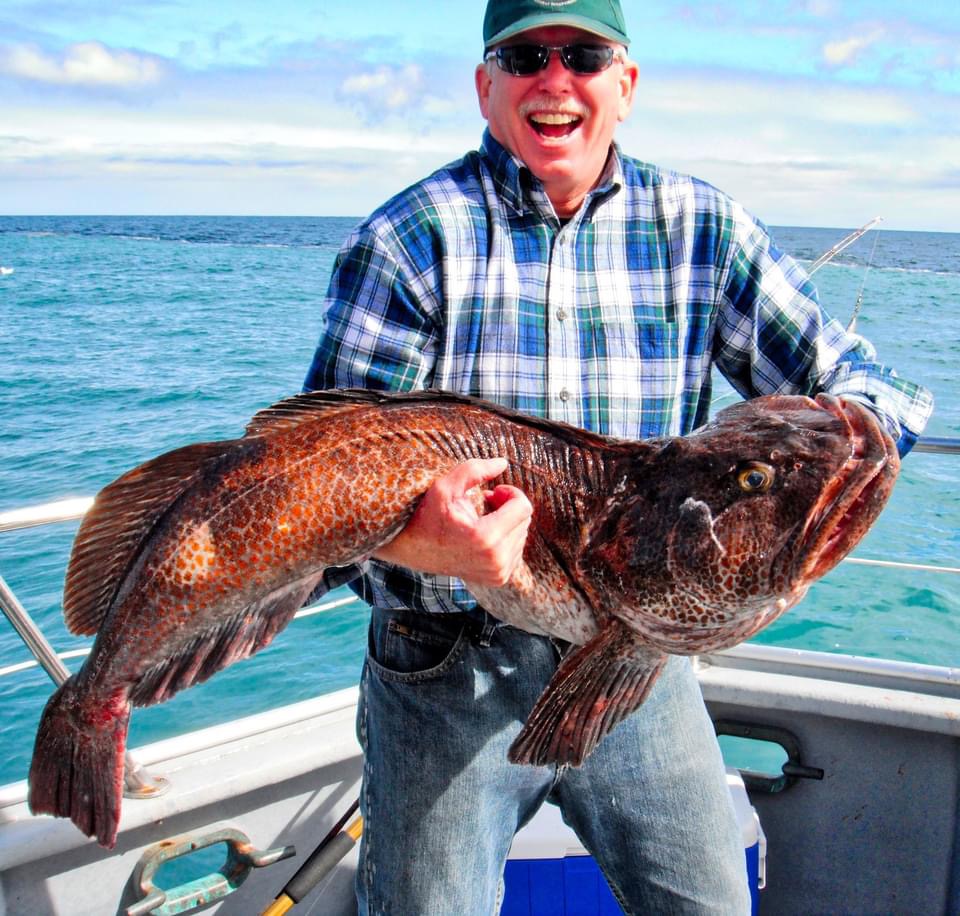 Happy angler with a large lingcod catch