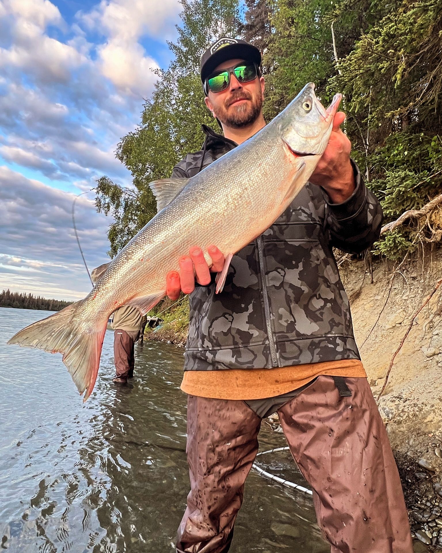 Angler holding a fresh-caught salmon on the Kenai River