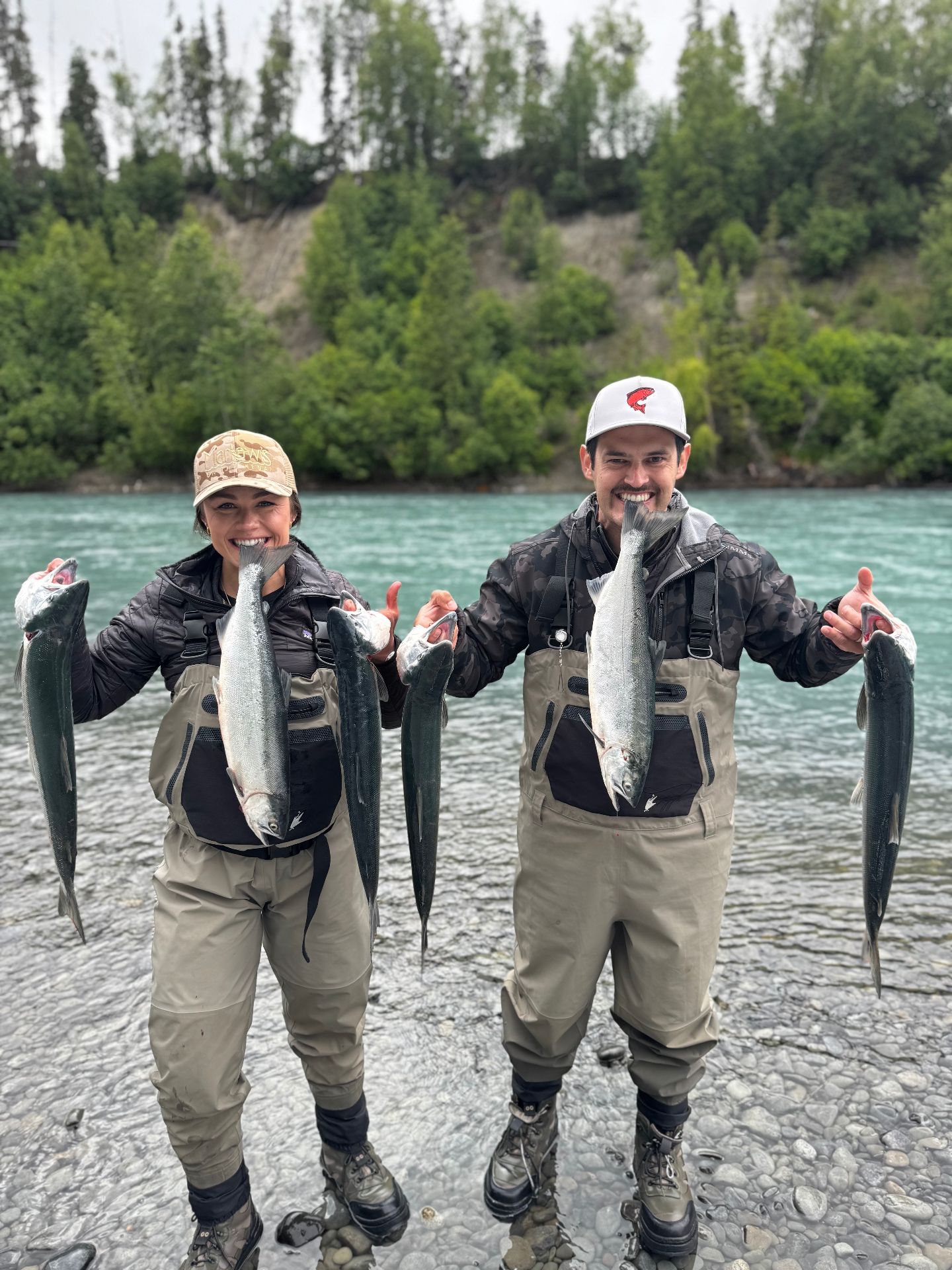 Couple holding up their silver salmon catch