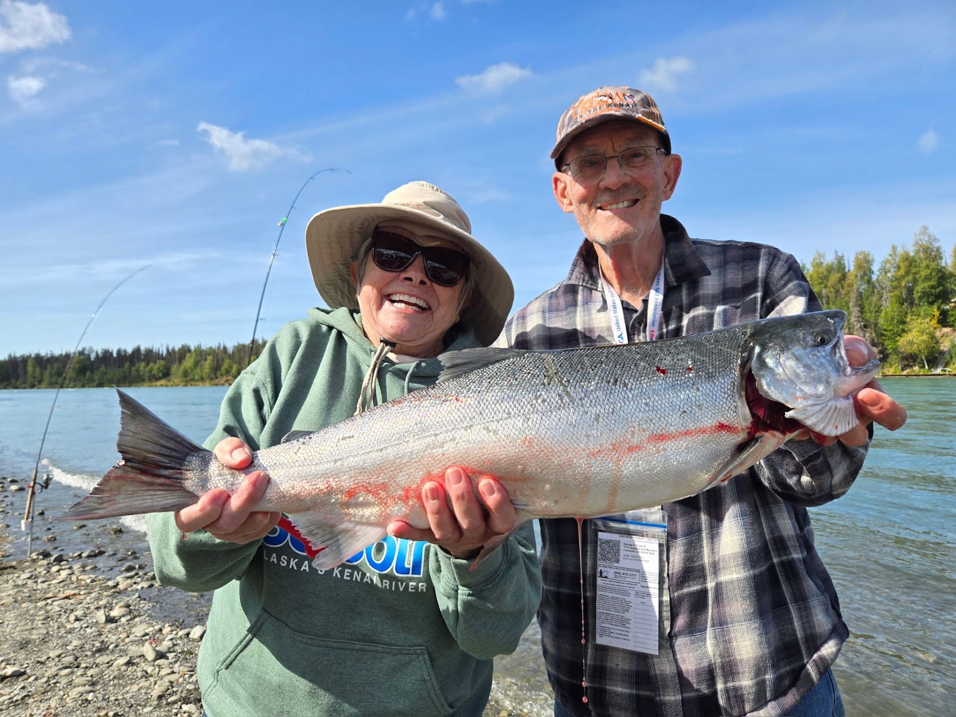 Couple smiling with a large salmon catch