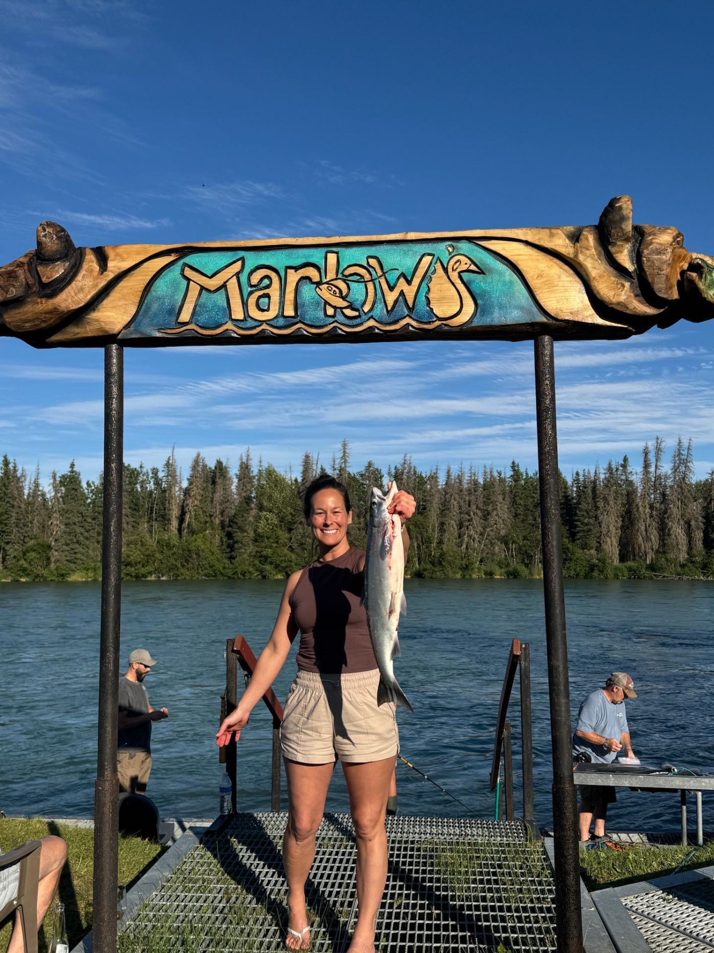 Angler holding a salmon on the dock